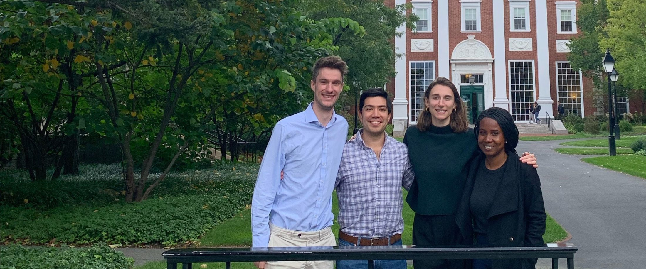 Group of 4 SMF's standing behind a Harvard Business School Sign